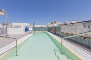 a swimming pool on the roof of a building at Soho Boutique Cádiz in Cádiz