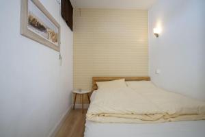 - une chambre avec un lit et un mur blanc dans l'établissement Bellevue-Haus-C-Wohnung-21, à Großenbrode