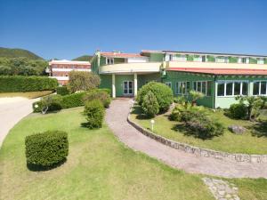 an aerial view of a house with a garden at Lu' Hotel Porto Pino in SantʼAnna Arresi