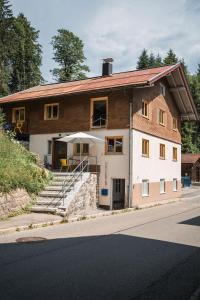 a house that is on the side of a street at Ferienwerk in Ofterschwang