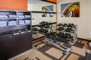 a gym with several racks of towels and weights at Courtyard Atlanta Airport West in Atlanta