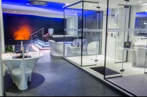 a bathroom with a bath tub and a sink at Les Secrets Rooms in Hagondange