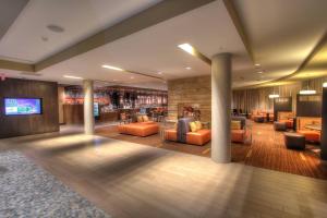 a lobby of a hotel with couches and a tv at Courtyard by Marriott Gatlinburg Downtown in Gatlinburg