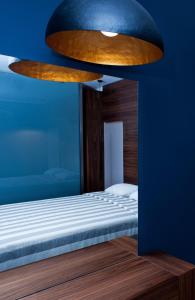 a bedroom with a bed and a blue wall at Frideriki Studios & Apartments in Platanias