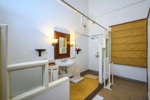 a bathroom with a sink and a mirror at Neemrana's - Baradari Palace in Patiāla