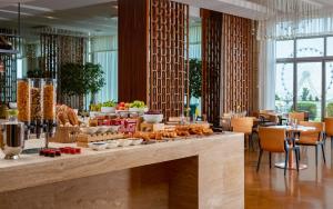 a buffet in a restaurant with food on a counter at Sheraton Baku Intourist in Baku