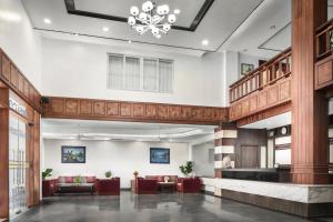 a lobby of a hotel with red furniture and a chandelier at Ohana Phnom Penh Palace Hotel in Phnom Penh +42 photos