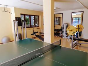 a gym with a ping pong table and weights at Asti Arthotel in Sinemorets