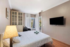 a bedroom with a bed and a flat screen tv at La Quinta in Santa Úrsula