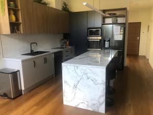a large kitchen with marble counter tops and appliances at Luxe & Superior 2BR Villas Patio Free Parking & Wifi in Launceston