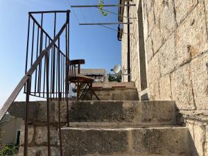 a set of concrete stairs with a metal railing at House Mate in Podgora