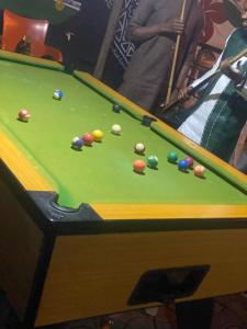 a pool table with balls on top of it at Belmorris Hotel in Ilorin