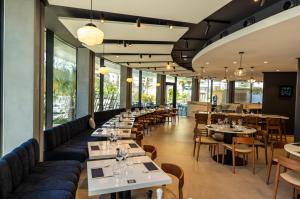 a restaurant with tables and couches and chairs at Crowne Plaza - Marseille Le Dôme in Marseille