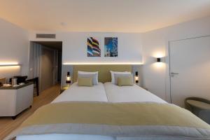 a bedroom with a large bed with two pillows at Crowne Plaza - Marseille Le Dôme in Marseille