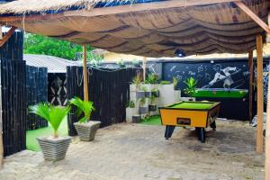 a backyard with a pool table and a fence at Belmorris Hotel in Ilorin