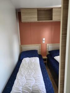 a bedroom with two beds and a bunk bed at Tussen ´Zee & Meer´ in Lauwersoog