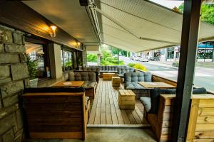 a restaurant with couches and tables on a patio at Hotel La Chaumière Garage Moto gratuit Hôtel à 100 m du télécabine in Saint-Gervais-les-Bains