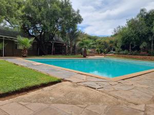 a swimming pool in the yard of a home at N4 Guest Lodge in Rustenburg