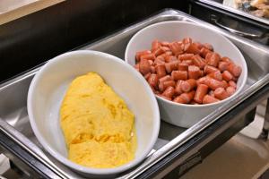 a tray with two bowls of food and a omelet and carrots at Wakayama Urban Hotel in Wakayama