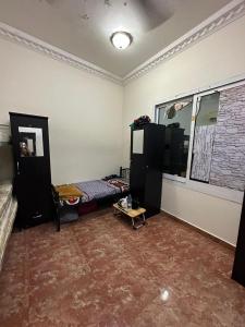 A television and/or entertainment centre at Bed Space for Female single and bunk bed Al Sayed Builidng - Sharaf DG Exit 4 Flat 301