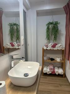 a bathroom with a white tub and a sink at Via ca´ls Avis in Campredó