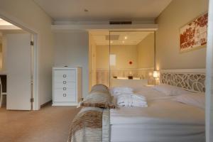 a bedroom with a large bed with a large mirror at Noorus SPA Hotel in Narva-Jõesuu