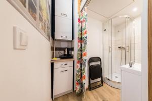 a small bathroom with a sink and a shower at Micro Apartments 2,5 qm - Najmniejsze Apartamenty Świata 2,5 mkw in Krakow