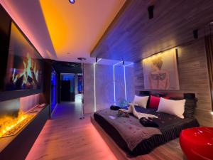 a living room with a couch and a fireplace at Les Secrets Rooms - Bonneval - Love Room - Spa et Hammam Privatif in Bonneval