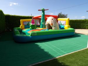 a small inflatable playground in a yard at THITOME in Limeuil