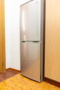 a stainless steel refrigerator in the corner of a room at Homestay in Tbilisi center GM in Tbilisi City