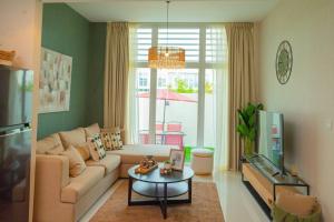 a living room with a couch and a table at Exquisite Villa - Elegant Living in Dubai