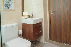 a bathroom with a toilet and a sink and a mirror at Exquisite Villa - Elegant Living in Dubai +10 photos