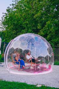 two people sitting inside of a glass igloo at Lotus Sapanca-Private Villa with private Pier and heated pool in Serdivan
