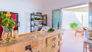 a room with a wooden counter with wine glasses on it at Tenuta Bukkuram in Pantelleria