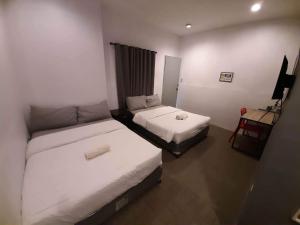 Postel nebo postele na pokoji v ubytování Hometown Hotel - Lacson Bacolod + 34 fotografií