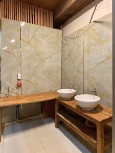 two sinks on a wooden table in a bathroom at Coliving The GK House, cheap, Bungalow, rooftop and restaurant, city center, local experience in Ho Chi Minh City