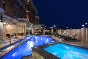 a swimming pool in a hotel at night at Courtyard by Marriott San Angelo in San Angelo