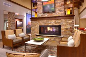 a living room with a fireplace with chairs and a table at Courtyard by Marriott Sedona in Sedona