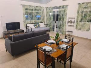 a living room with a couch and a table at Taharu'u Guest House By The Beach in Papara