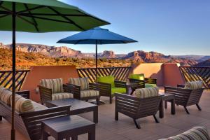 a patio with chairs and tables and an umbrella at Courtyard by Marriott Sedona in Sedona