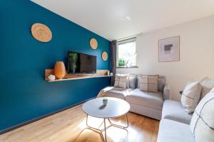 a living room with a couch and a table at The Wapping Villas in London