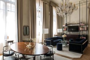 a living room with a table and chairs at Nolinski Venezia - Evok Collection in Venice