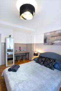 a bedroom with a large bed with a large light at ClickTheFlat Muranów Apart Rooms in Warsaw