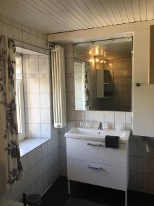 a bathroom with a sink and a mirror and a shower at Eifel-Moezelhuis in Bergweiler