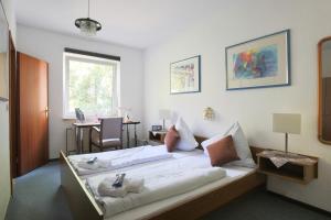 a bedroom with a bed with two stuffed animals on it at Historisches Hotel Rathaus in Lautenthal