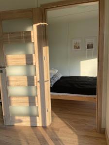 a bedroom with a bunk bed with a mirror at Domki Nad Malowniczym Stawem / Raj Dla Wędkarzy / Mazury in Piecki