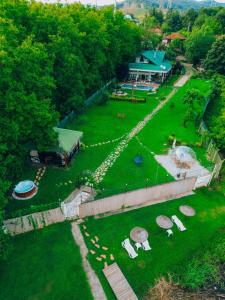 an aerial view of a garden with chairs and a building at Lotus Sapanca-Private Villa with private Pier and heated pool in Serdivan