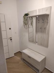a white room with a table and a mirror at Apartman Smokva in Kumbor