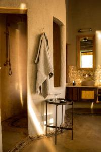 a bathroom with a towel hanging on the wall at Molori Safari in Derdepoort