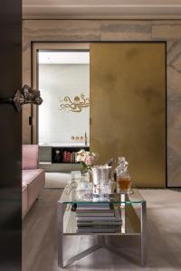 a living room with a glass coffee table at Nolinski Venezia - Evok Collection in Venice